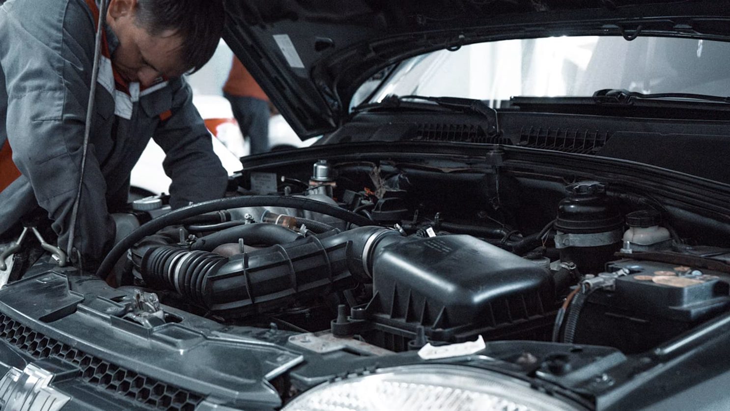 Mechanic inspecting a car engine bay